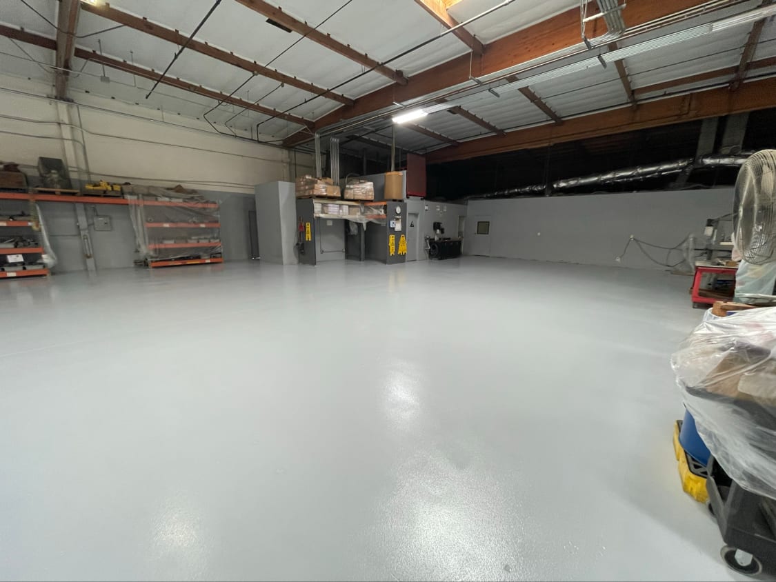 Glossy white resin floor coating in an industrial unit