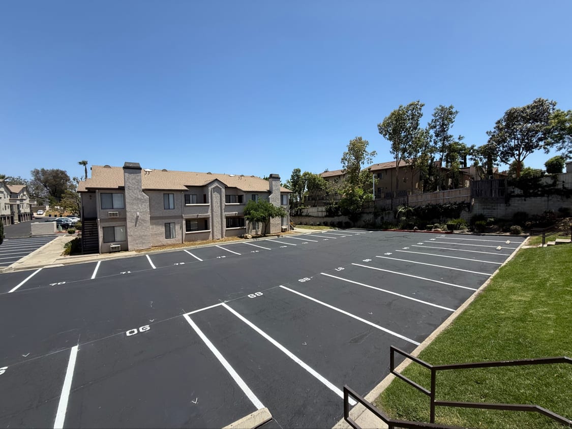 Newly sealed residential community parking area with crisp white stall markings