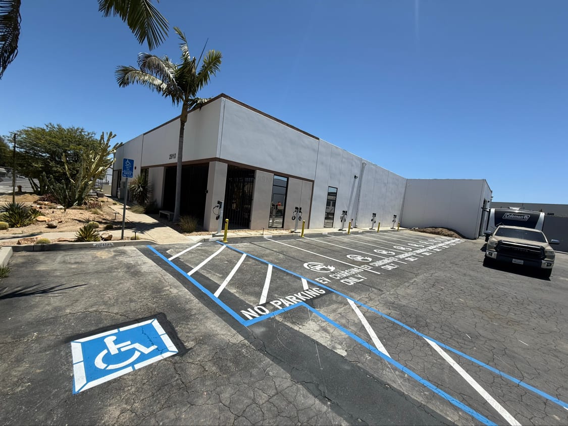 Accessible parking stalls with blue markings, access aisle hatching and signage